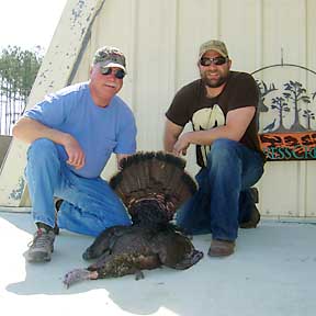 Robert and his son Chris with a young gobbler