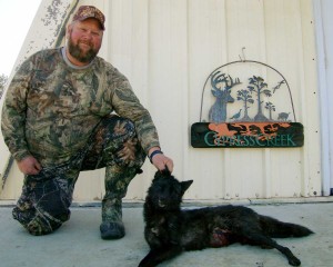 Brent with a young black coyoe