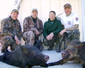 Brook, Bill, Shawn and Josh with two of their hogs