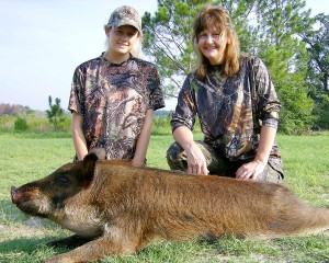 Katie with her mom Jamie and her hog