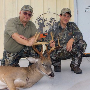 Steve with his son and giant buck