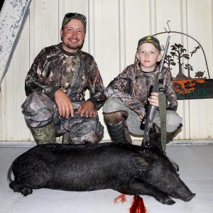 Rob with son Rocky and his 1st wild hog