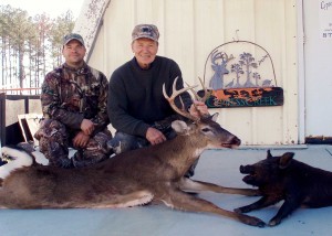 Jeff with his dad Charlie and his great buck and meat hog